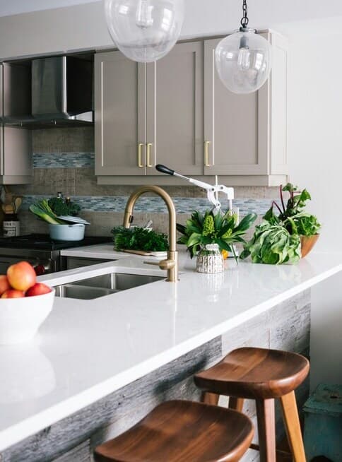 A freshly cleaned kitchen sink with soft morning light reflecting off the faucet